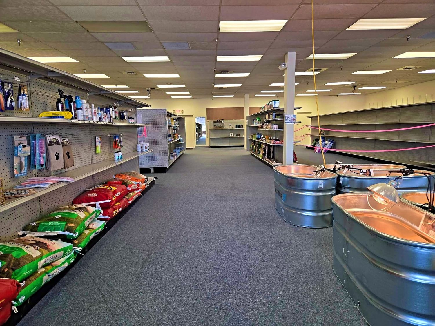 Long aisle with feed bags and stock tanks