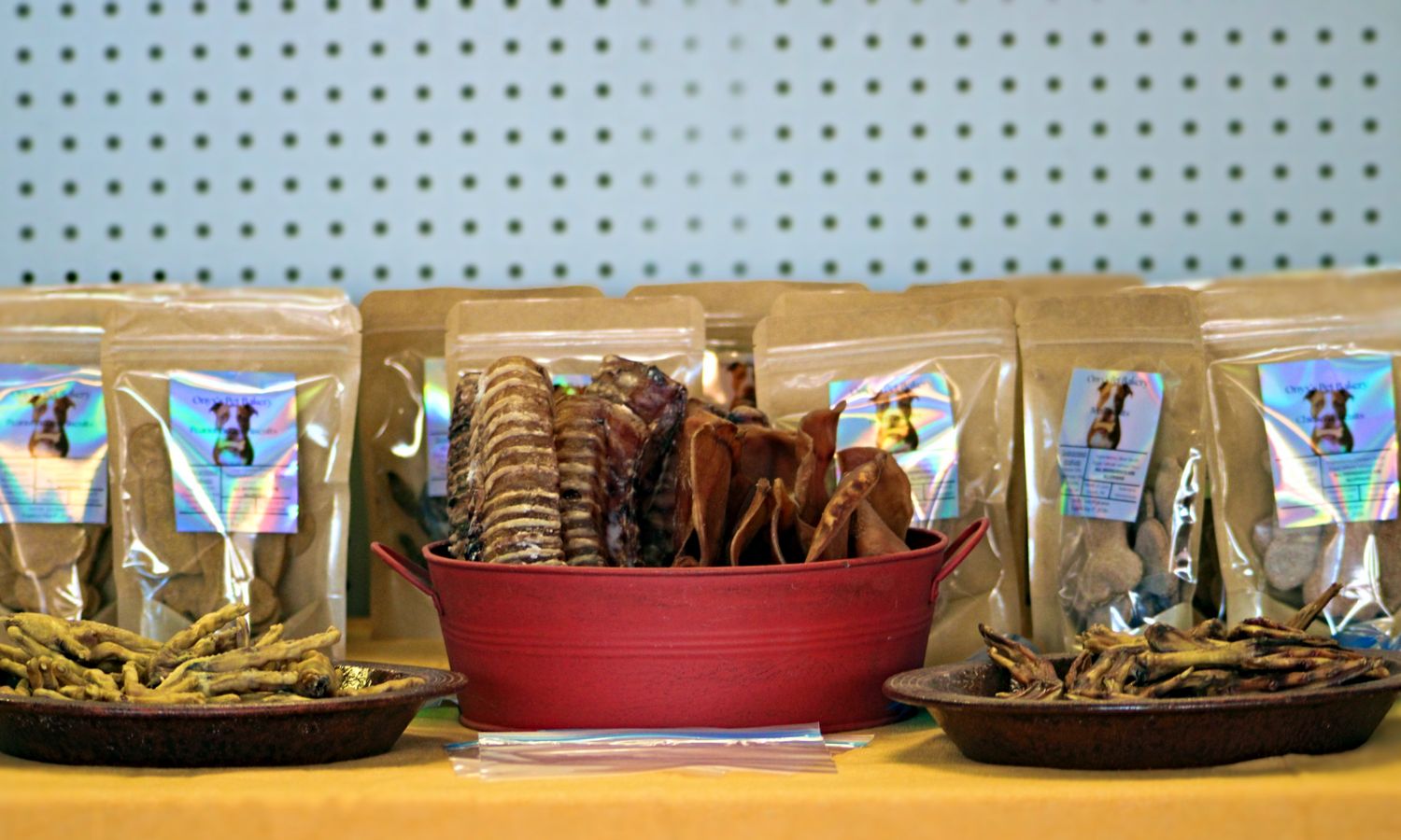 Display of all-natural dog treats and biscuits in a red tub